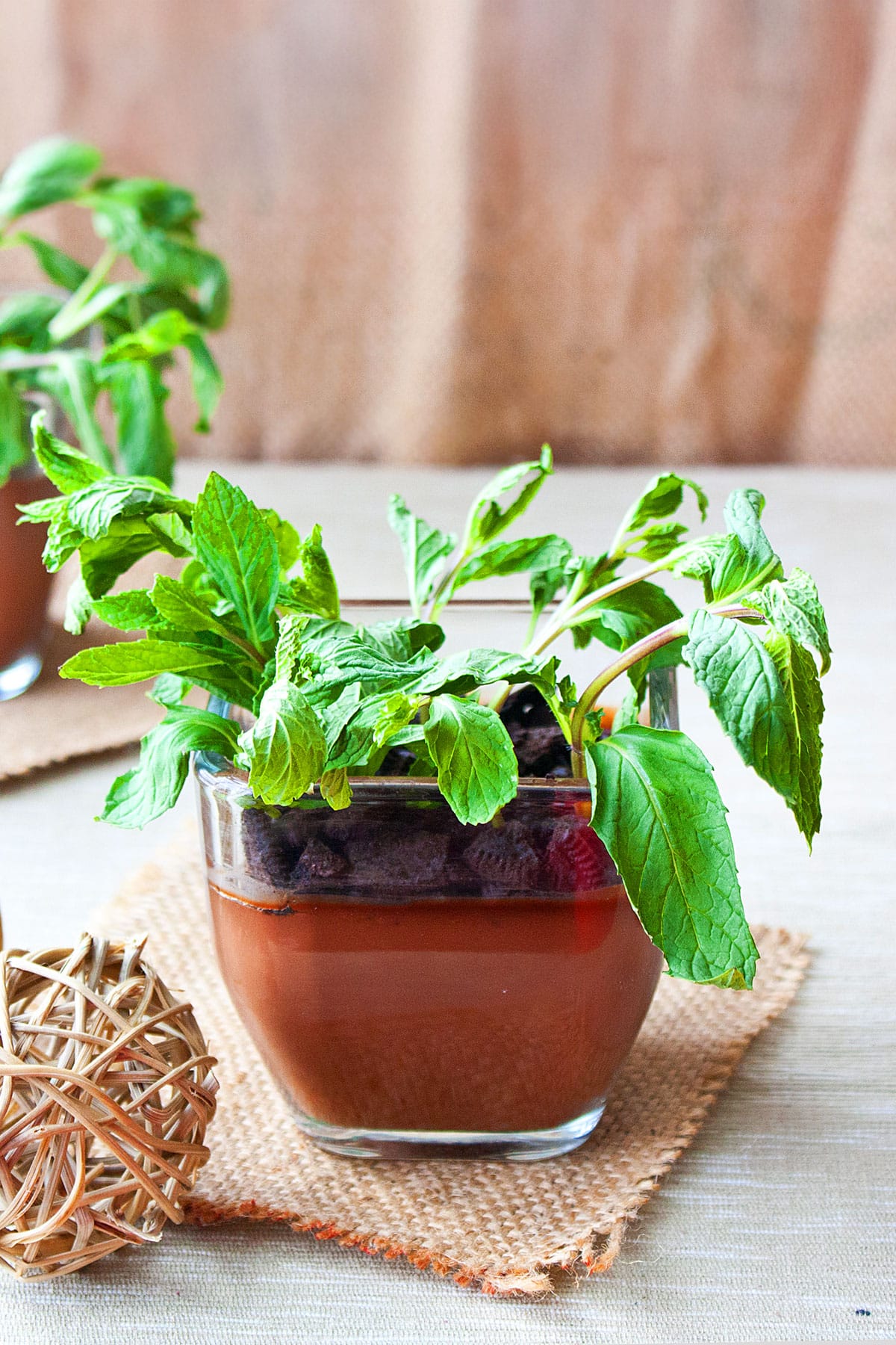 Chocolate Pudding Pots or Dirt Pudding Cups on Rustic Brown Background.