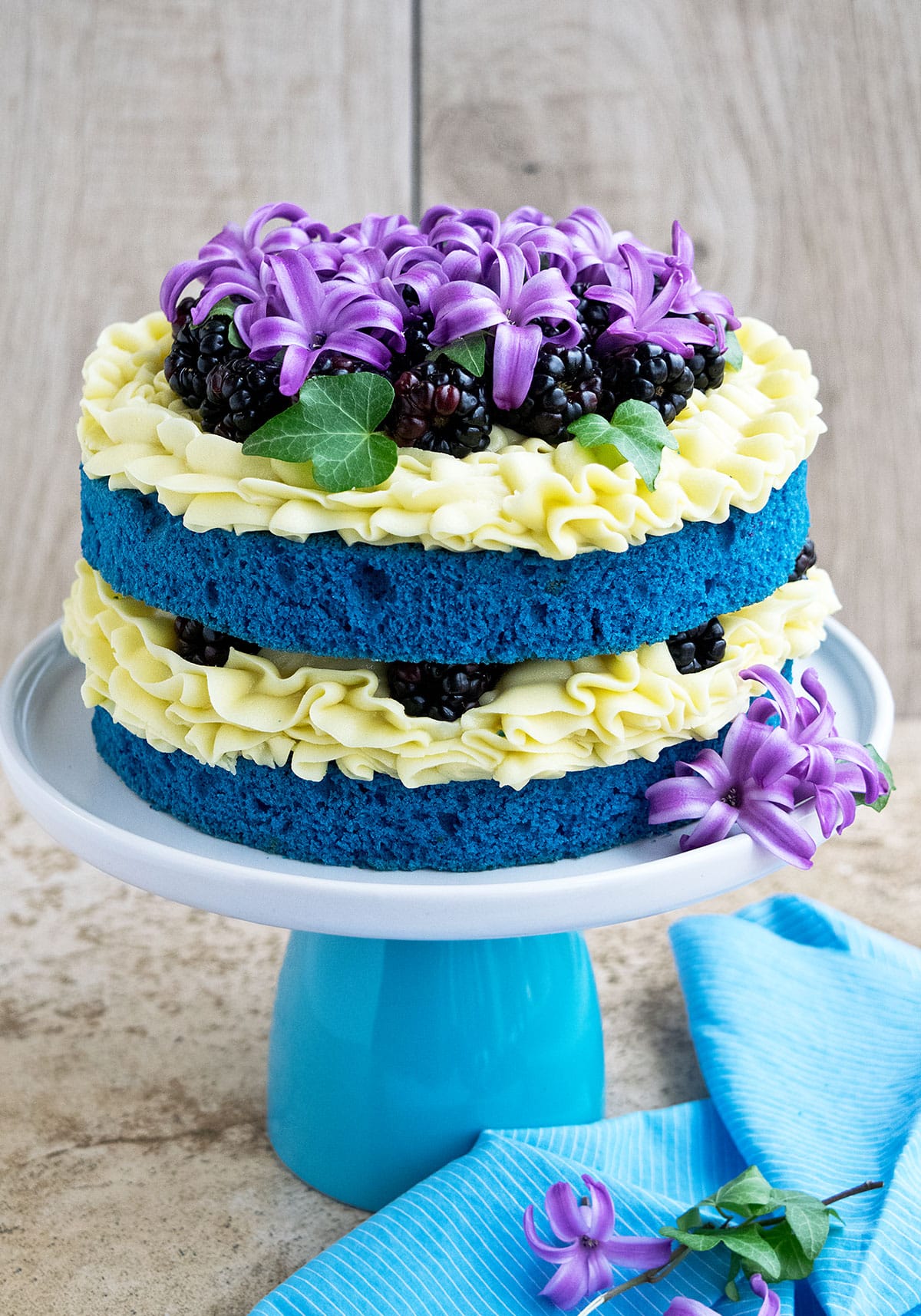 Easy Naked Cake with Flowers and Fruits on White Stand.
