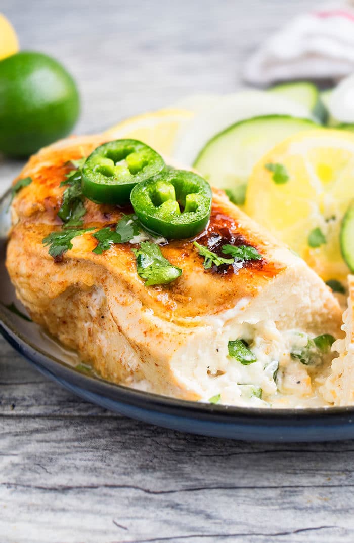 Spicy Chicken Breast Stuffed With Cheese on White Dish With Black Rim.