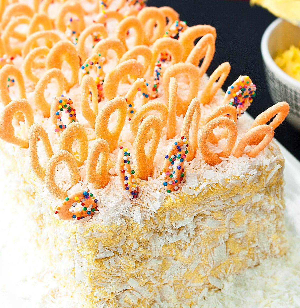 Closeup shot of chocolate loop decorations on top of cake. 