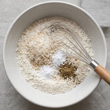 Dry ingredients being whisked together in large bowl. 