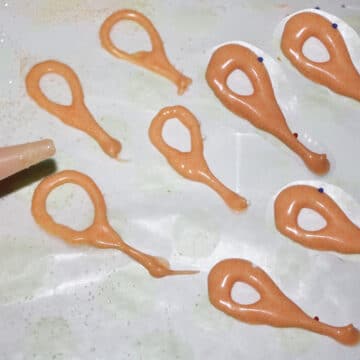 Chocolate loop decorations piped on sheet of wax paper. 