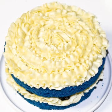 Yellow frosting piped on top of cake.