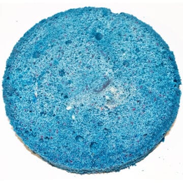 Round blue cake on white background.