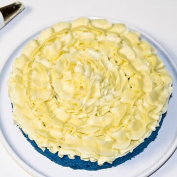 Yellow frosting piped on top of cake.