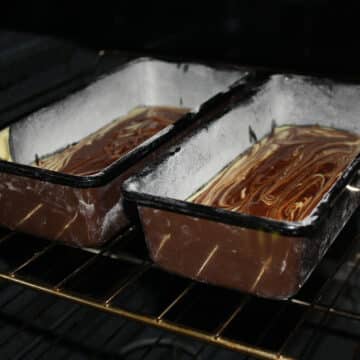 Loaf pans with batter in oven ready to bake.