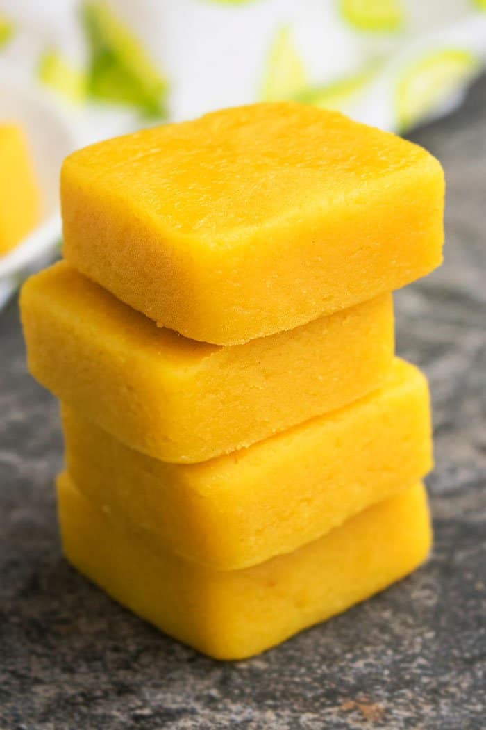 Stack of Easy Lemon Fudge on Rustic Background.