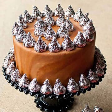 Marble Fondant Cake With Hershey's Kisses on Black Cake Stand.