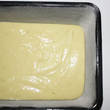 Cake batter spread in a loaf pan. 