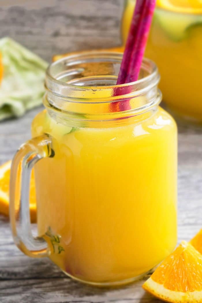 Easy Orangeade in Glass Mug With Pink Straw. 