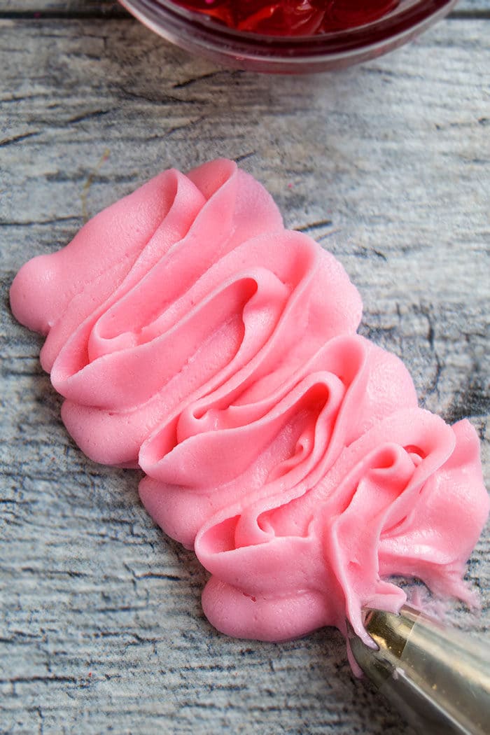 Easy Homemade Pink Frosting Piped on Gray Background
