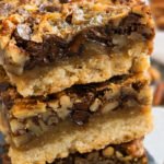 Stack of Easy Southern Chocolate Pecan Pie Bars With No Corn Syrup on Black Dish.