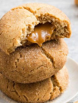 Stack of Stuffed Caramel Snickerdoodles on White Plate With Caramel Oozing Out