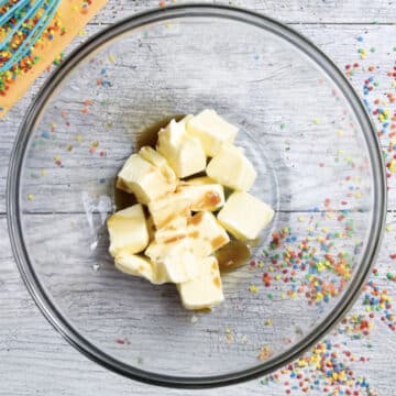 Butter and vanilla extract in glass bowl. 