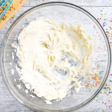 Creamed butter and vanilla in glass bowl. 
