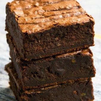 Stack of Fudgy Chocolate Avocado Brownies on Rustic Gray Background.