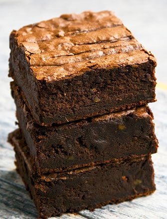 Stack of Best Easy Avocado Brownies on Gray Wood Background.