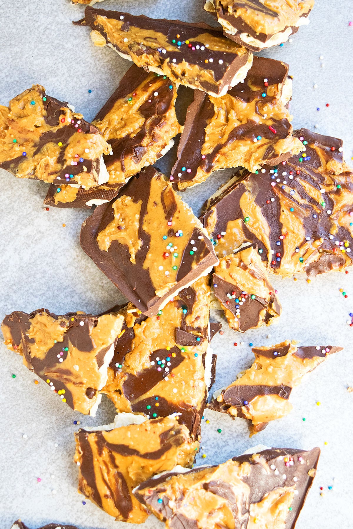 Broken Up Pieces of Swirled Chocolate on Light Gray Background.