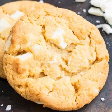 Easy White Chocolate Macadamia Nut Cookies on Rustic Black Tray.