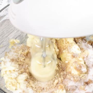 Butter, brown sugar and granulated sugar being creamed together in glass bowl. 