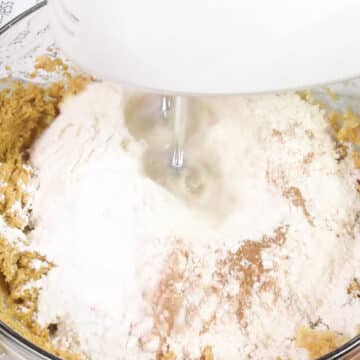Dry ingredients added to wet ingredients in glass bowl. 