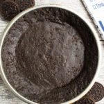 Easy No Bake Oreo Pie Crust on Rustic Gray Background- Overhead Shot.