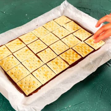 Layer of saltine crackers added to top of melted chocolate. 