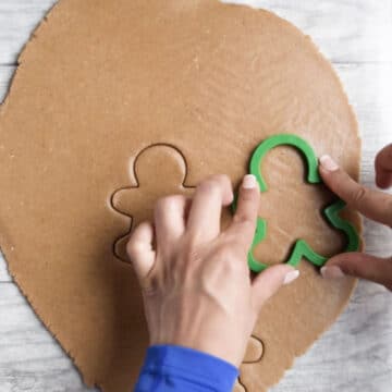 Cutters being used to cut out cookie shapes. 