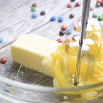 Butter and egg in glass bowl about to be mixed. 