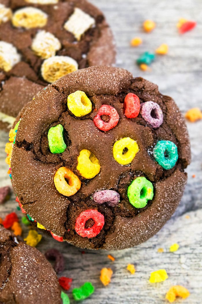 Chocolate Cookies With Ice Cream and Froot Loops Cereal Topping on Rustic Gray Background. 