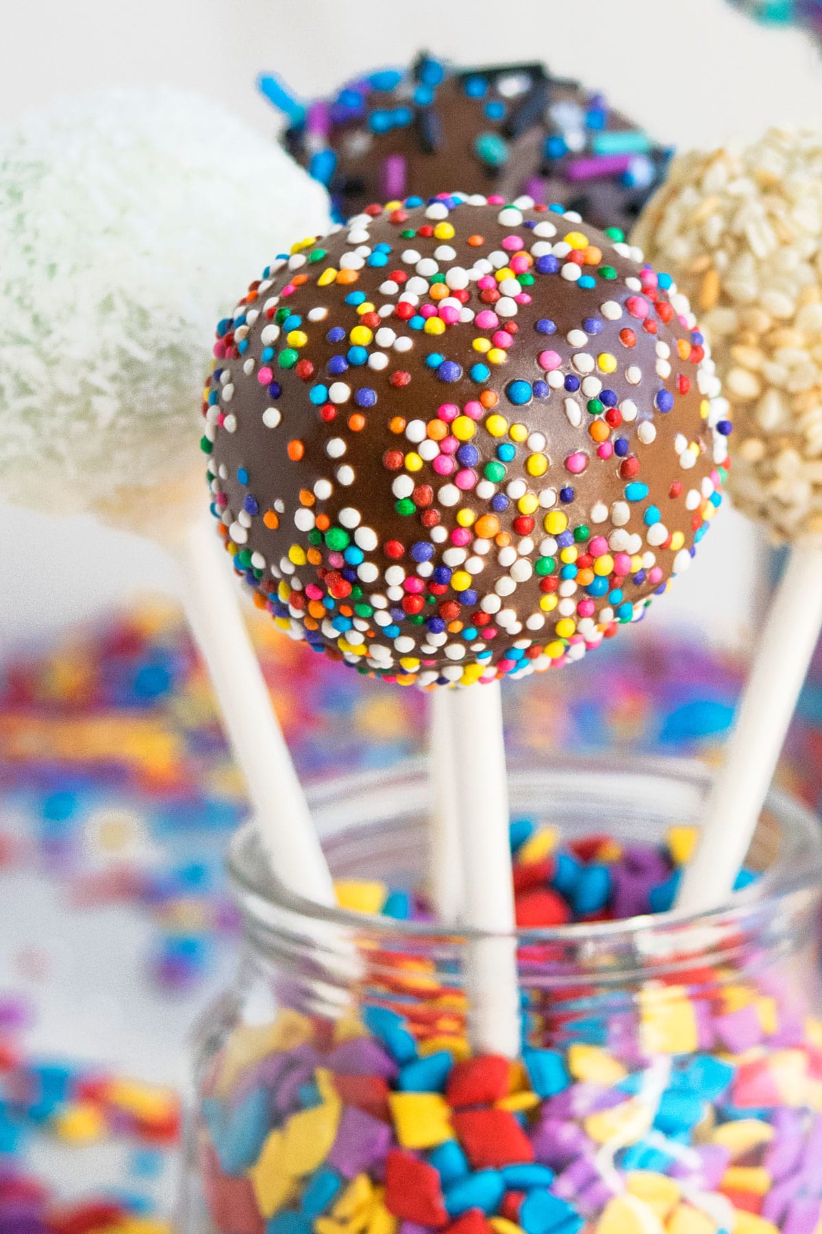 Easy Homemade Cake Pops in Glass Jar of Sprinkles. 