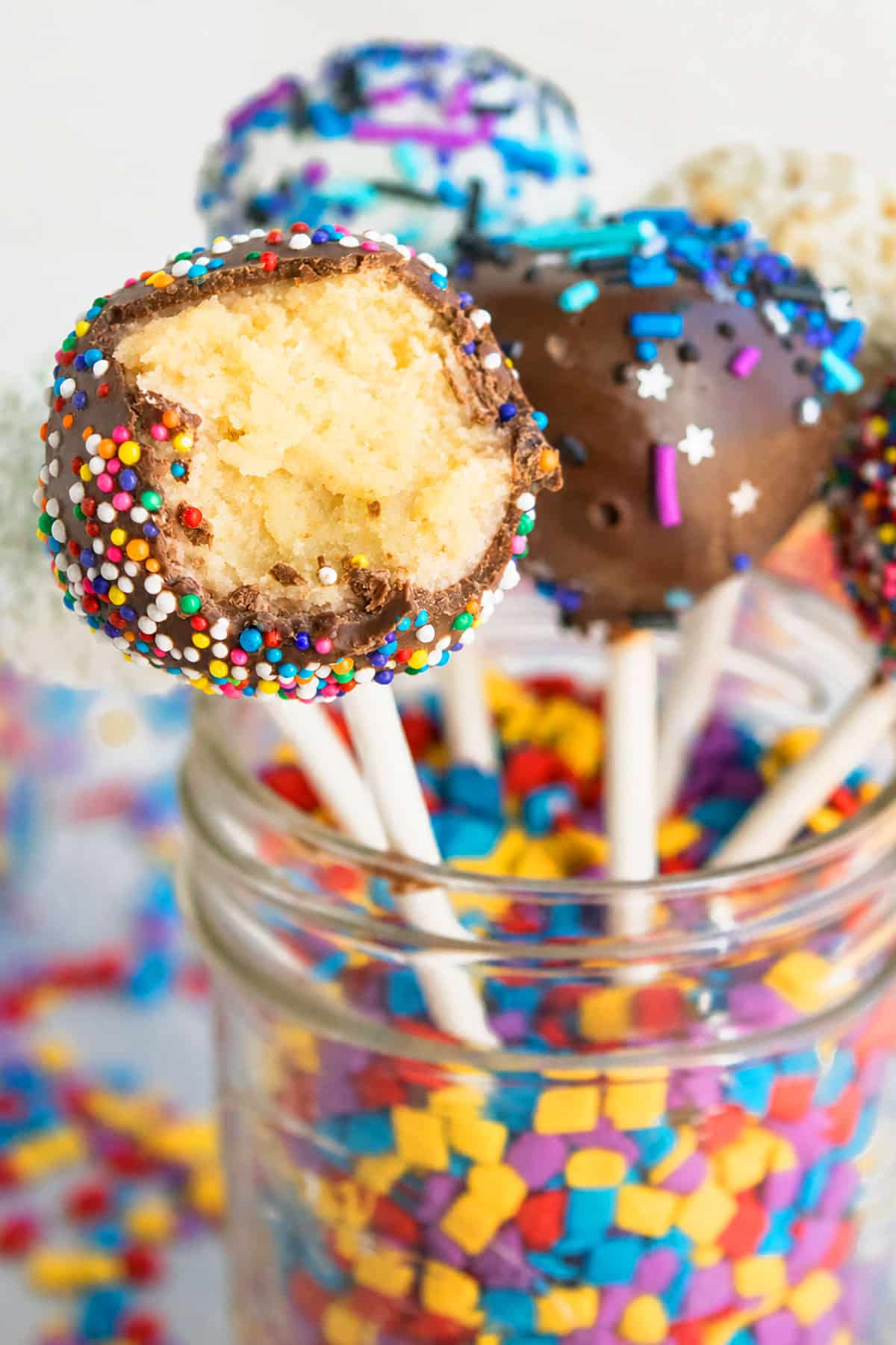 Partially eaten pop in a jar of sprinkles- Closeup shot. 