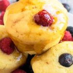 Stack of Easy Pancake Muffins With Fresh Fruits and Maple Syrup on White Dish.