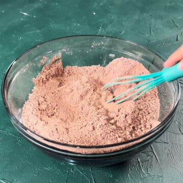 Dry ingredients being whisked together in large bowl.
