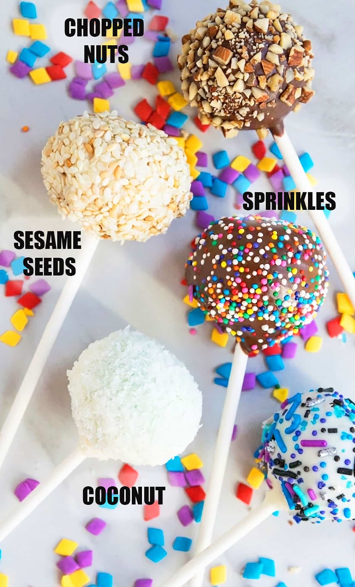 Labeled image with variety of pops with different toppings on white marble background. 