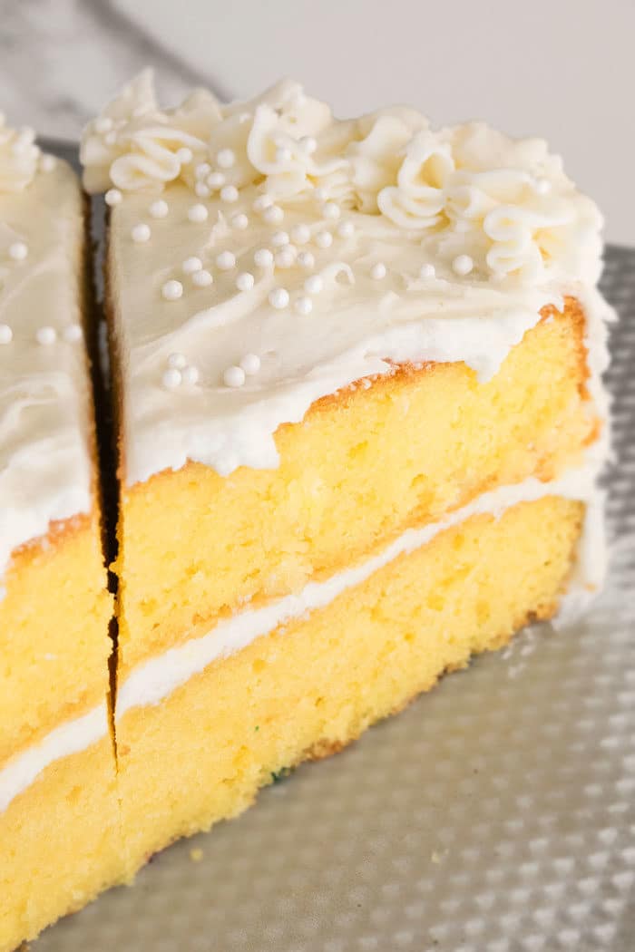 Easy Vanilla Layer Cake With Buttercream Icing That\'s Decorated With White Edible Pearls. 