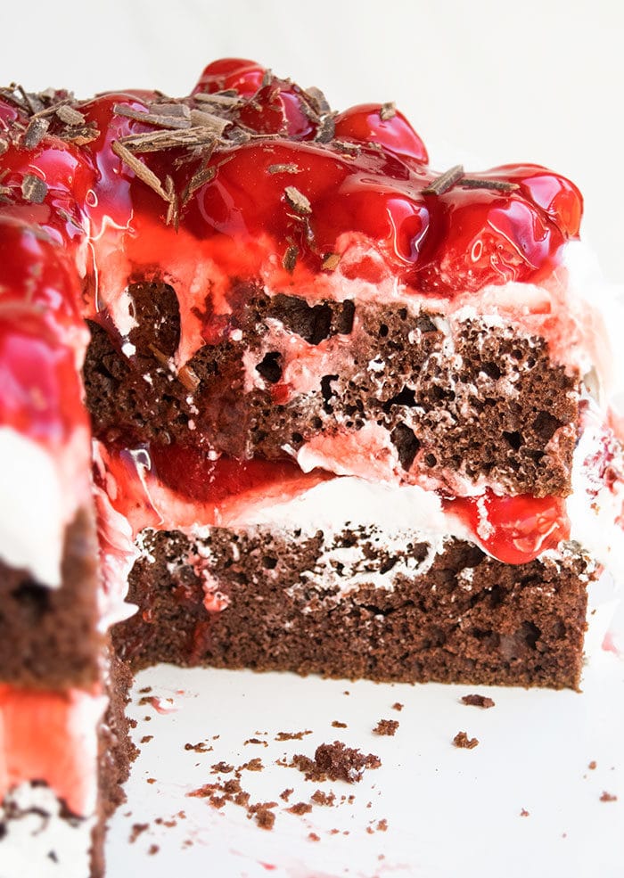 Partially Sliced German Black Forest Gateau on White Dish