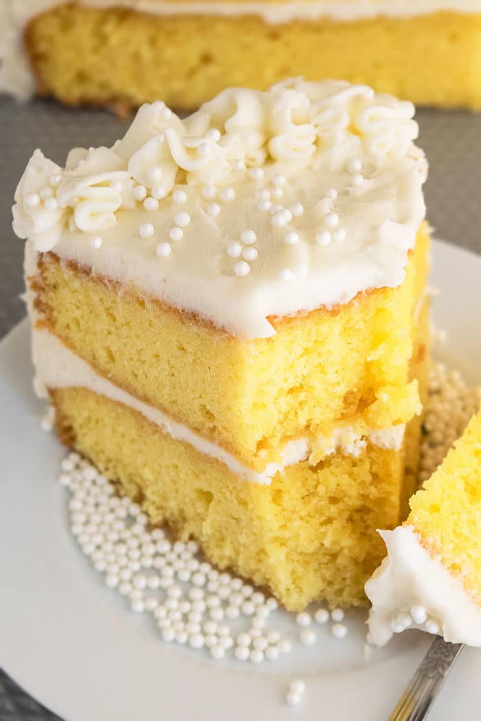 Slice of Homemade Vanilla Cake on White Dish That\'s Partially Eaten. 