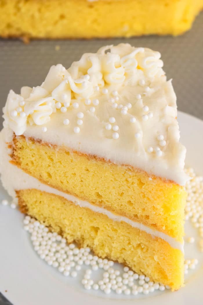 Slice of Best Vanilla Cake From Scratch on White Dish. 