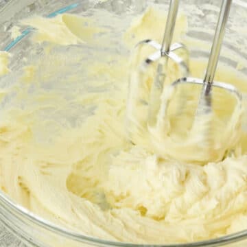 Ingredients being mixed together in a glass bowl. 