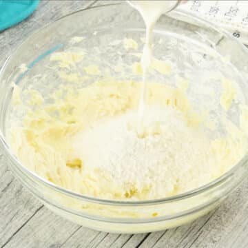 Milk and alternate sugar being added to creamed butter. 