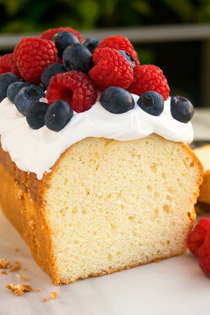 Best Cream Cheese Pound Cake With Topping of Whipped Cream and Fresh Berries. 