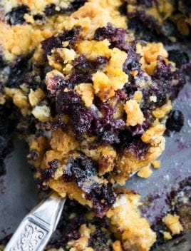 Spoonful of Blueberry Dump Cake (Blueberry Cobbler Dump Cake) in Gray Pan