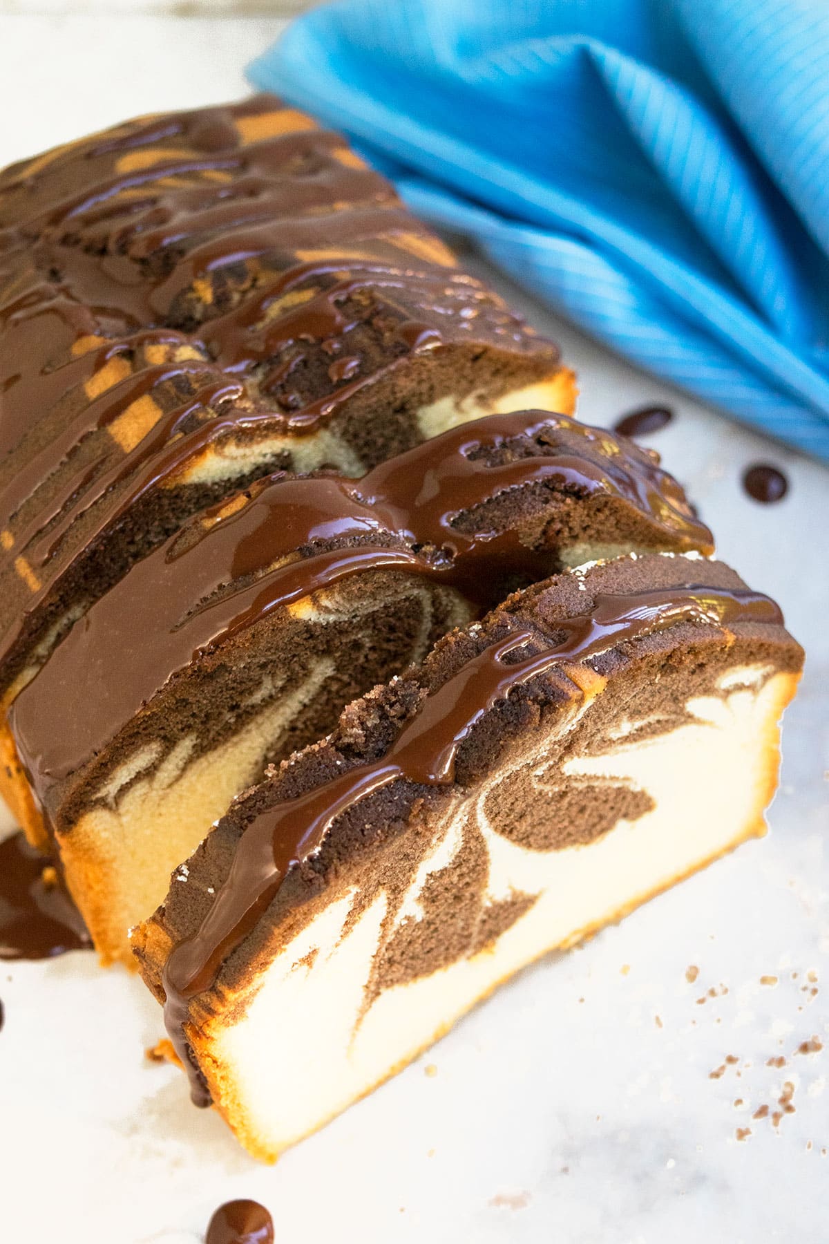 Chocolate ganache loaf cake on white dish.