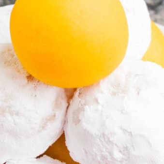 Tower of Lemon Cake Balls or Cake Truffles- Some Coated in Powdered Sugar.