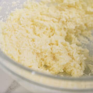 Creamed butter and sugar in glass bowl.