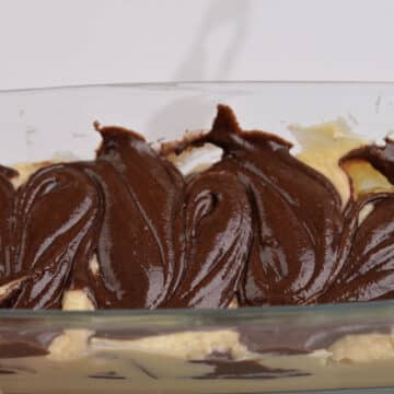 Chocolate batter swirled into vanilla cake batter with knife or skewer.