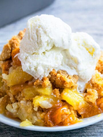 Peach Dump Cake With Cake Mix in White Dish.
