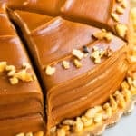 Best Easy Chocolate Caramel Cake on White Dish With Chopped Nuts Topping.