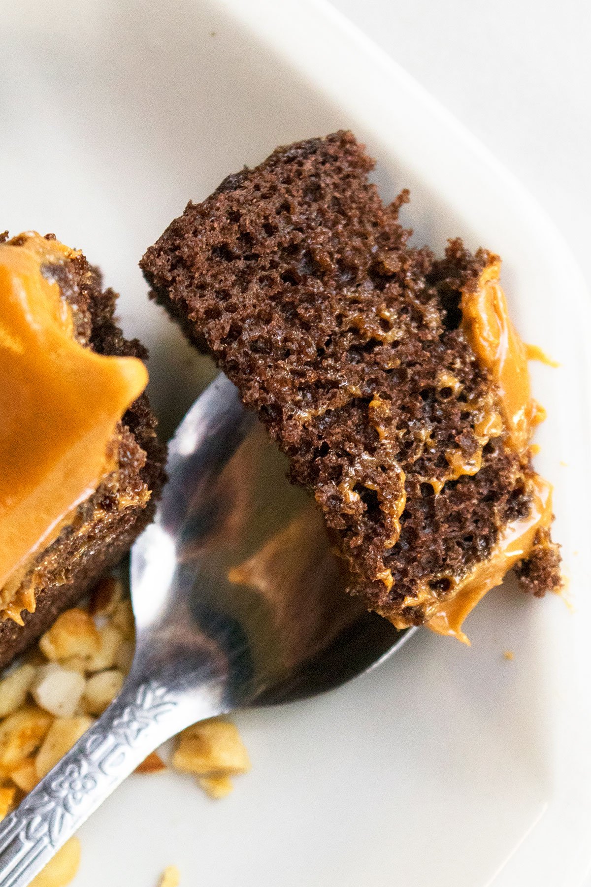 Spoonful of Cake on White Dish- Closeup Shot. 